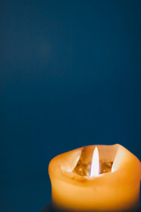 Yellow holiday candle on blue background, luxury branding design and decoration for Christmas, New...