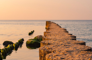 Breakwater at sunset time on the Baltic coast
