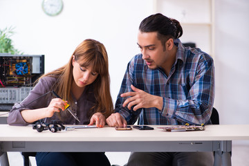 Two technicians working at computer warranty center