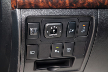 View to the interior of car with dashboard, mirror adjust button after cleaning before sale on parking