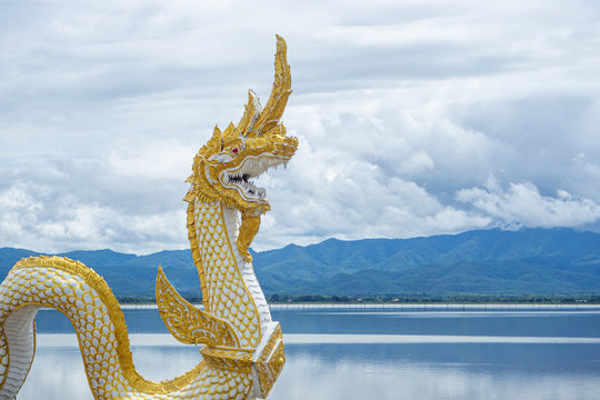 Naga statue with sky, cloudy and lake background
