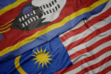 waving colorful flag of malaysia and national flag of swaziland.