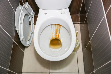 Old dirty toilet bowl. Rust in the bathroom.