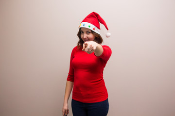 happy girl in santa hat in red blouse on white background 