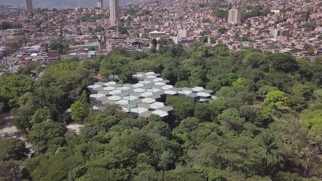 Beautiful slow tilting shot of trees and Jardin Botanico in Medellin, Colombia, Parque Explora