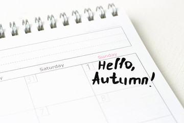 The inscription Hello, autumn on a white calendar, close-up