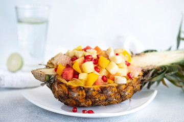 Natural eating. Fruit salad on white background - diet, healthy breakfast. Gourmet food. Tropical fruit. Diet healthy food, nutrition. Fresh fruit. Juicy natural fruit. Healthy food dinner table.