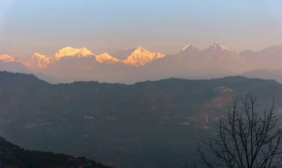 Papier Peint photo Kangchenjunga A view of Snow clad Kangchenjunga, also spelled Kanchenjunga, is the third highest mountain in the world. It lies between Nepal and Sikkim, India,  