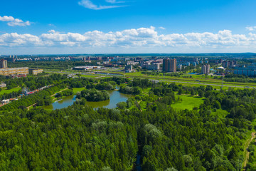 Aerial view of South Seaside Park on southwest part of St. Petersburg city. Summer, a lot of green trees, blue sky. Russia