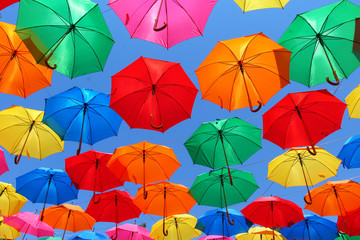 Fototapeta na wymiar colored umbrellas on a background of blue sky
