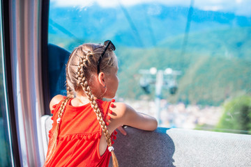 Adorable little girl in the cabin on the cable car © travnikovstudio