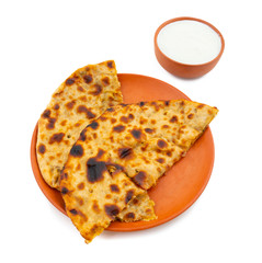 Indian Traditional Breakfast Dish Aloo Paratha is a Potato Stuffed Flatbread Served With Fresh Curd on White Background