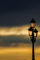 Old traditional Venice street lamp at sunset in a romantic and unique atmosphere (with copy space)