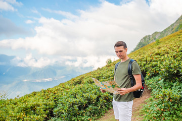 Fototapeta premium Tourist man in mountains in the background of fog