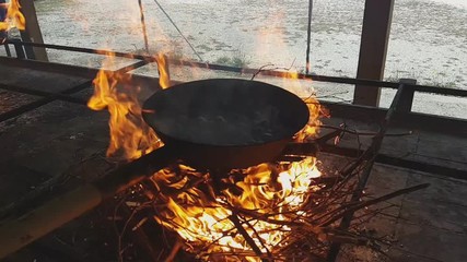 Chestnuts cooked in a characteristic traditional pan over fire