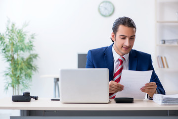 Young male businessman sitting in the office