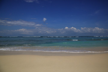 View from a beautiful white sandy beach on the ocean horizon and blue sky	