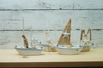 Nautical background with Sailboat Model on wooden background
