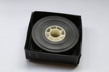 Small 35mm Movie Trailer Film Roll on a Bobby in a box. This is a 2-3 minute long film strip shipped to a movie theatre