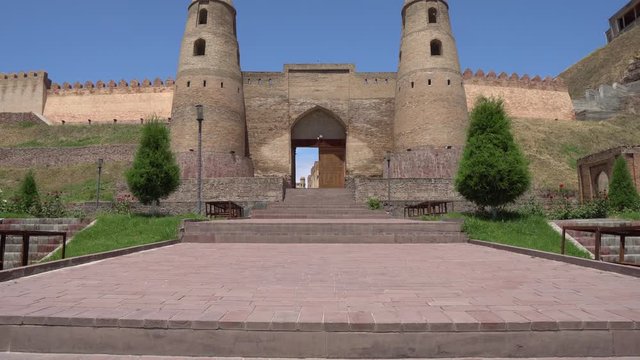 Hisor Fortress Main Gate Entrance with Walls Closeup View with Flying Birds on a Sunny Blue Sky Day