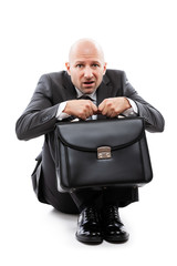 Unhappy scared or terrified businessman in depression hand holding briefcase