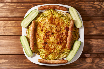 oven-fried vegetable pizza with cheese with cucumber and sausage.