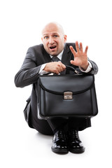 Unhappy scared or terrified businessman in depression hand holding briefcase
