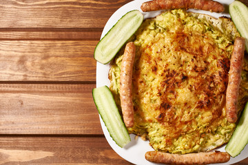 oven-fried vegetable pizza with cheese with cucumber and sausage.