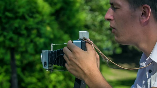 This photographer is taking photos with an old-fashioned camera.