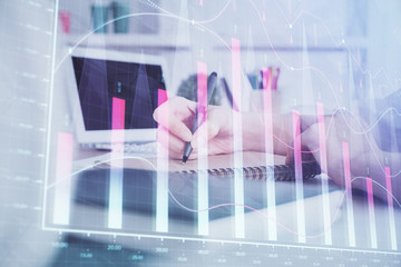 Financial graph displayed on woman's hand taking notes background. Concept of research. Double exposure