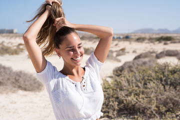 Young woman holding her hair in a pony tail