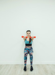 Sport, Fitness and People concept: Woman in sport equipment with hand weights 
