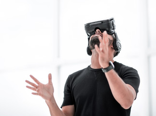 portrait of an amazed guy using a virtual reality headset isolated