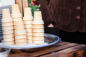Ice cream waffle cups are stacked. Street trade in ice cream.