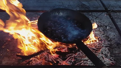 Steaming chestnuts while they are cooked over the fire, Vittorio Veneto, Italy
