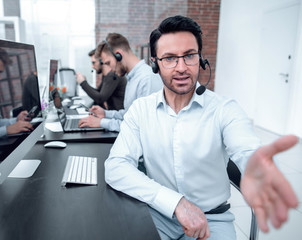 Obraz premium modern businessman in a headset reaching out for a handshake