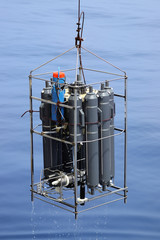 CTD rosette sampler with bathometers and other science equipment for measurement of underwater environment parameters like temperature, salinity and others.