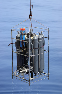 CTD rosette sampler with bathometers and other science equipment for measurement of underwater environment parameters like temperature, salinity and others.