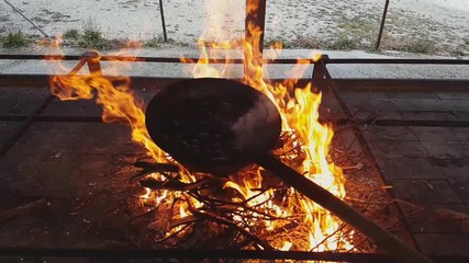 Slow motion of steaming chestnuts cooked over the fire, Vittorio Veneto, Italy