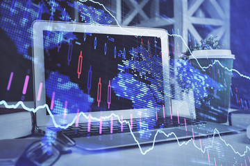 Forex market graph hologram and personal computer on background. Double exposure. Concept of investment.