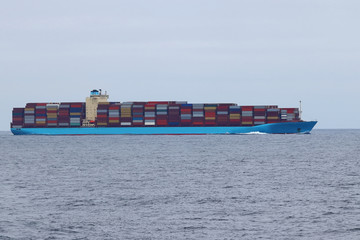 Container cargo ship underway in the ocean.