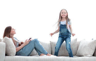 little girl jumping on the couch on the couch in the living room