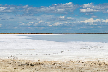 Obraz premium Camargue white salt flat lake, etang salt water lagoon surrounded by sand dunes, Southern France