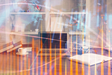 Financial chart drawing and table with computer on background. Double exposure. Concept of international markets.