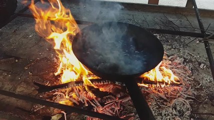 Slow motion of chestnuts while they are cooked over the fire, Vittorio Veneto, Italy