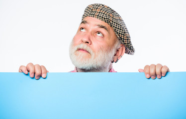 search for inspiration. dreaming mature man in retro hat. Senior bearded man place announcement on...