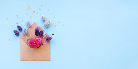 Obraz na płótnie Canvas Paper envelope with a bouquet of purple flowers.