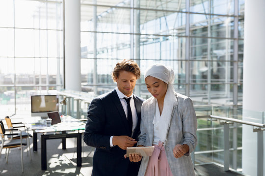 Business people working together on digital tablet in a modern office