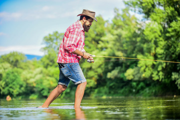 For me hobby is First. Successful fly fishing. summer weekend. fisherman show fishing technique use rod. experienced fisher in water. sport activity and hobby. man catching fish. man fly fishing