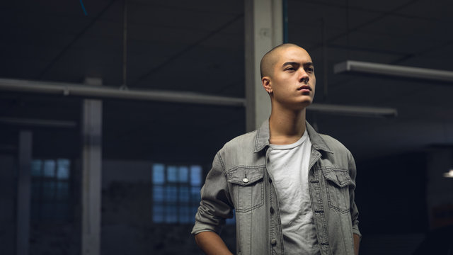 Young man inside an empty warehouse
